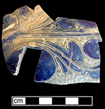 Gray-bodied salt glaze stoneware jug with engraved (incised) foliage motif painted in cobalt-blue under the glaze.  Note thickened area of glaze along the upper left side of the vessel, from 18CV60.